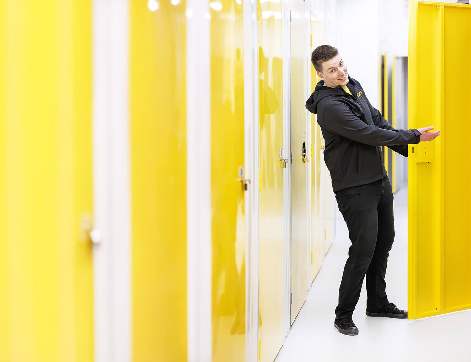 affordable storage solutions in Wellington Photo of a self storage facility manager showing a customer to a storage unit.