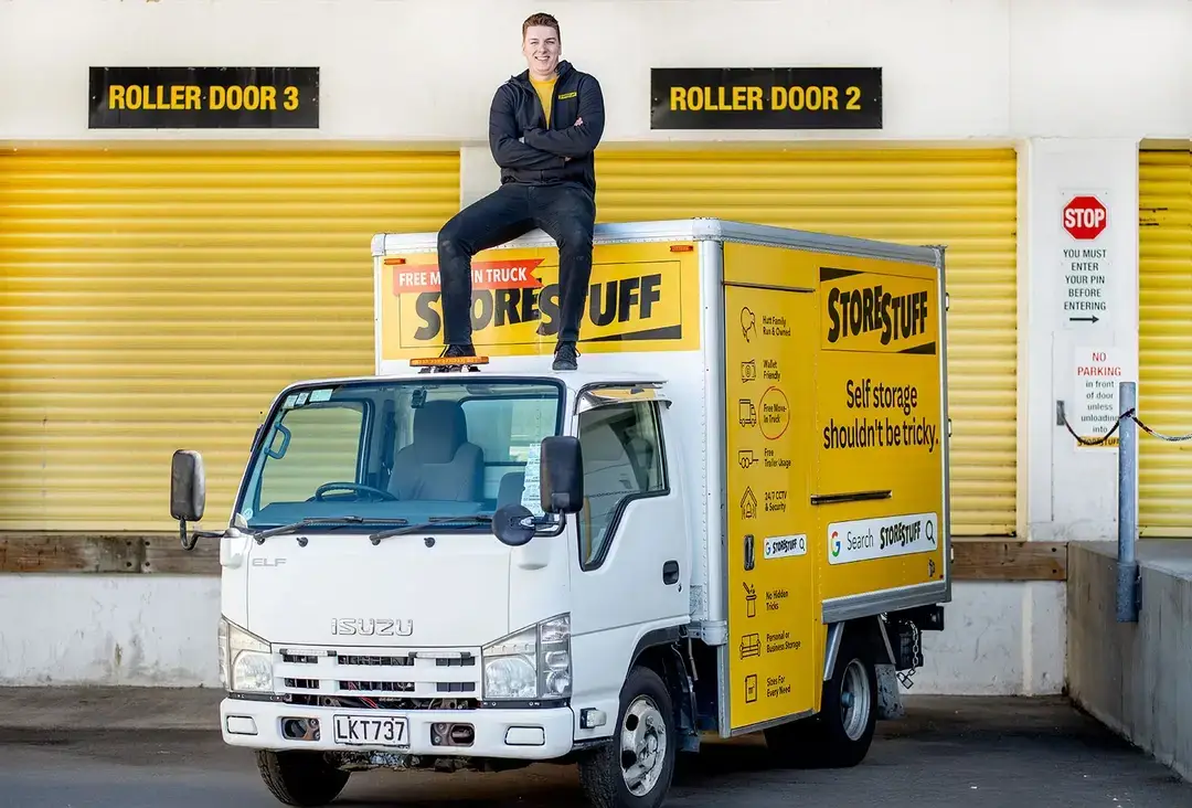 StoreStuff staff member on the free move-in truck deck beside yellow storage units